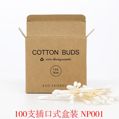 Brown cardboard box labeled "Cotton Buds" with a pile of bamboo-handled cotton swabs in front.