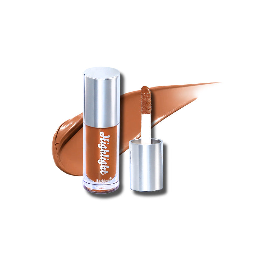 Luminous mirror lip gloss in a warm brown shade with a metallic silver cap and matching applicator swipe.