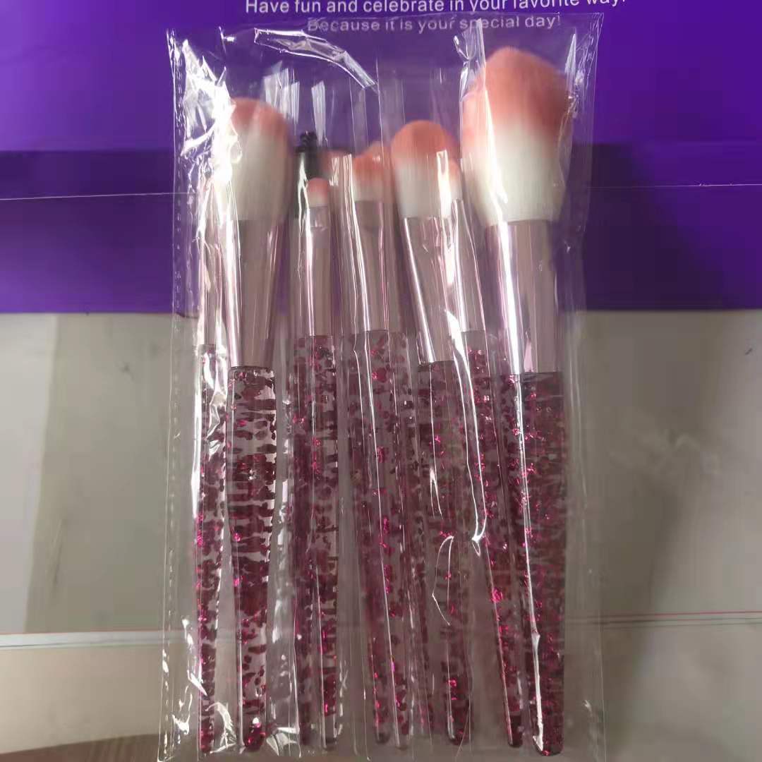 Beauty Master 10-piece makeup brush kit featuring clear handles with pink glitter and ombre pink-to-white bristles.