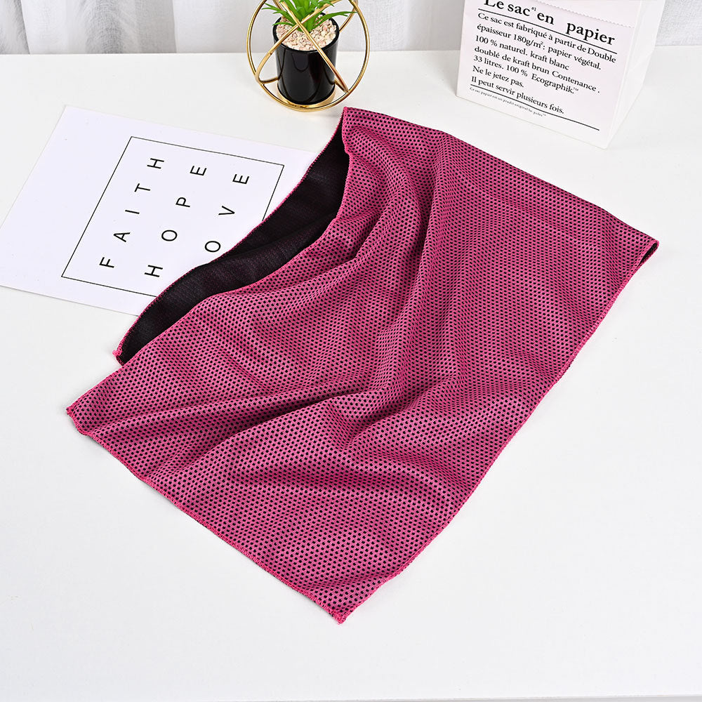 SwiftCool outdoor activity towel featuring a textured pink top layer and smooth black underside on a white surface.