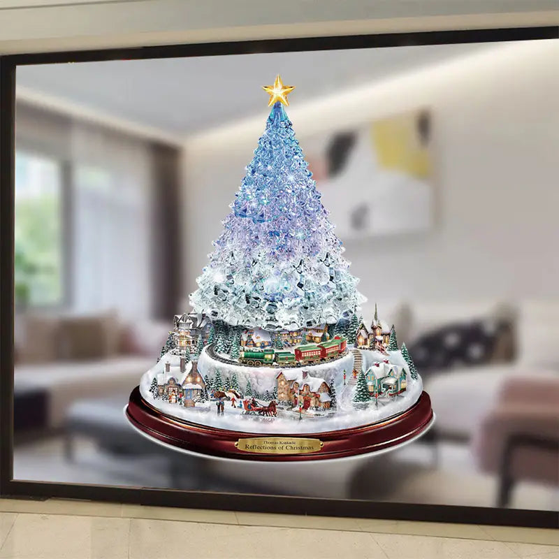 Christmas window decal featuring a crystalline blue and white tree atop a detailed, festive snowy village scene.