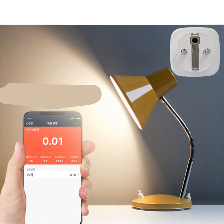 EuroConnect Smart Socket (white) shown with a yellow desk lamp and a smartphone displaying power usage statistics.