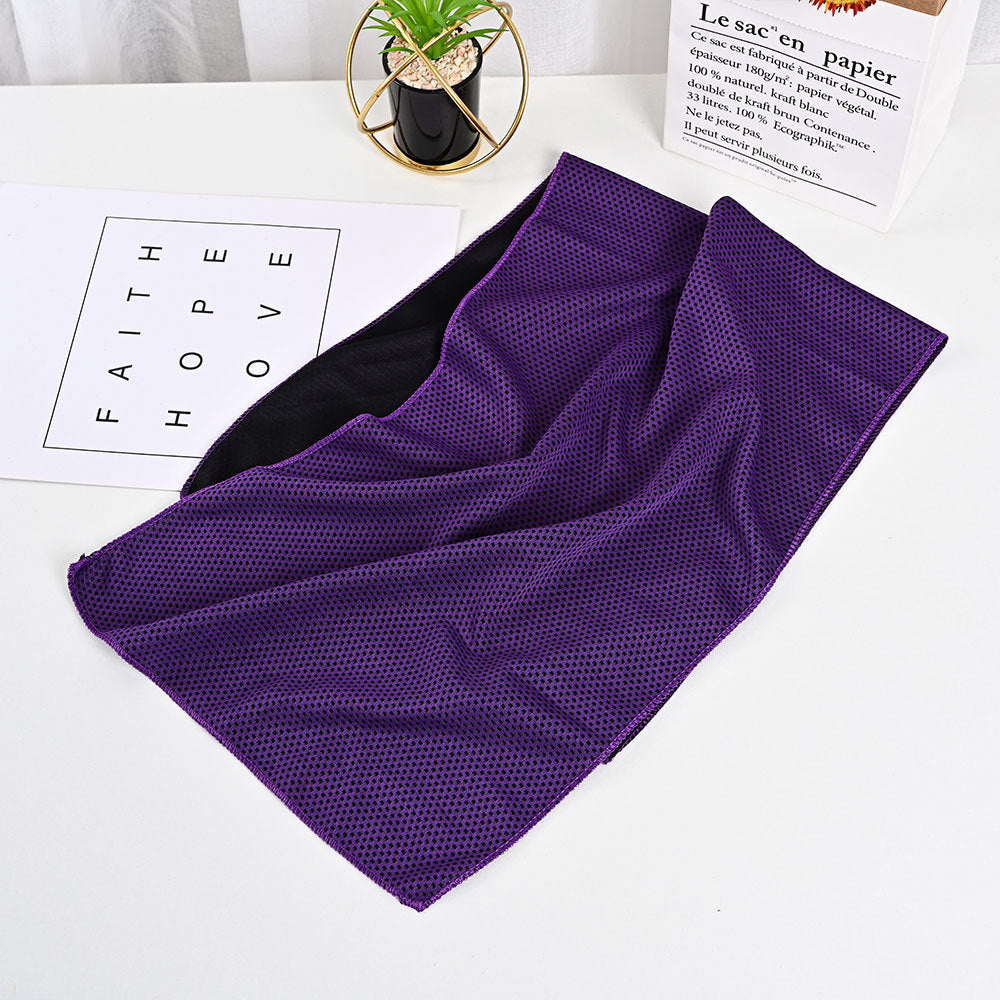 Purple, mesh-textured outdoor activity towel with a black interior lining, laid flat on a white surface.