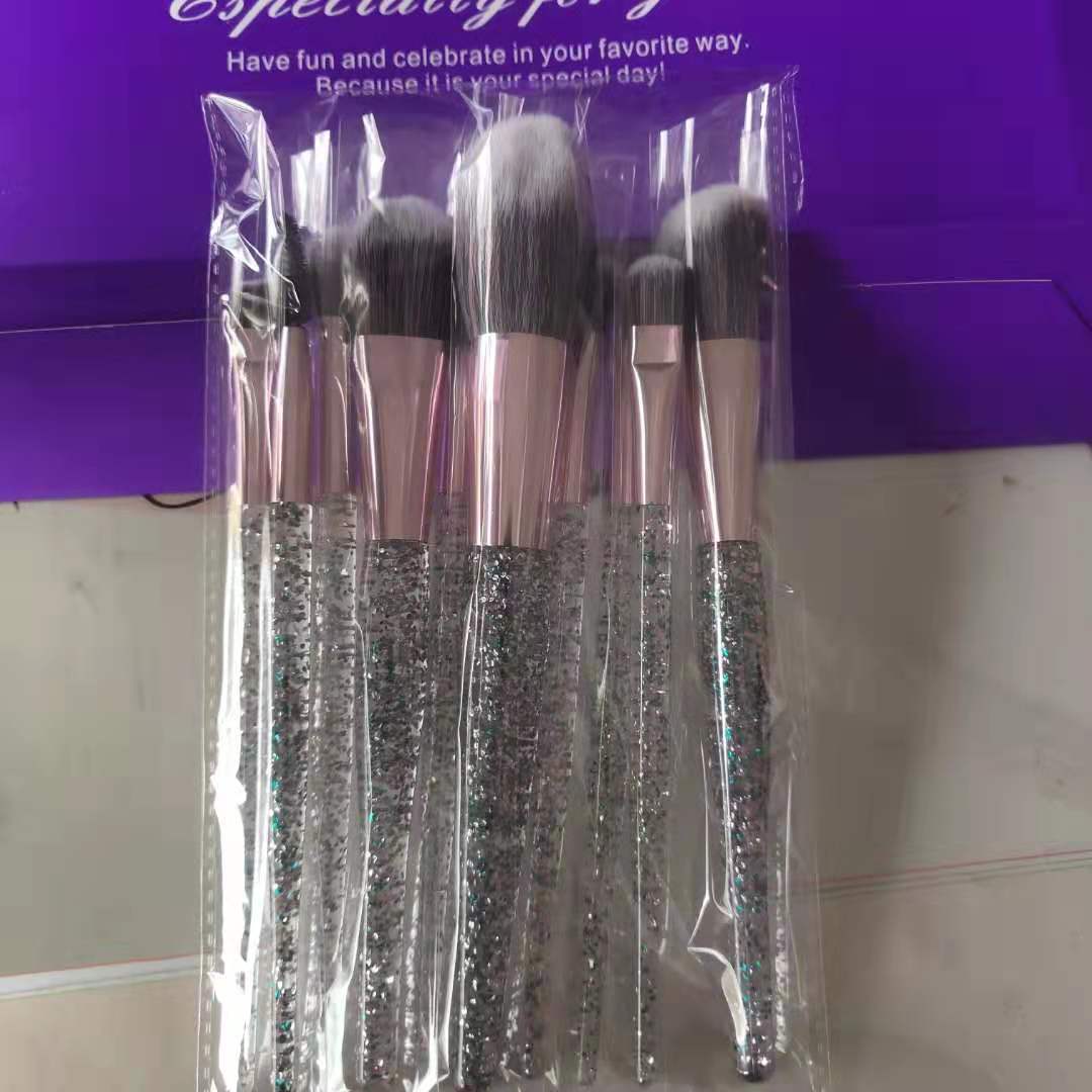Beauty Master 10-piece makeup brush set with sparkly silver glitter handles and rose gold ferrules in clear packaging.