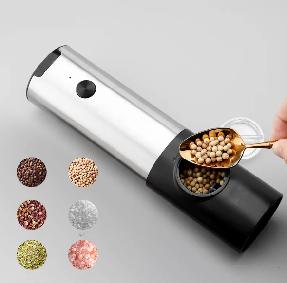 Stainless steel and black electric pepper grinder being filled with peppercorns, featuring six spice circle icons.