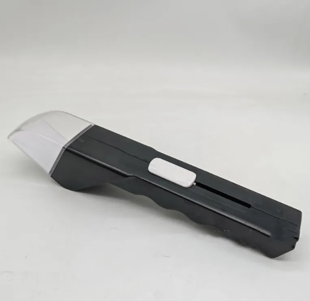 Portable bug and bee grabber with a black handle, white sliding switch, and clear plastic capture enclosure.