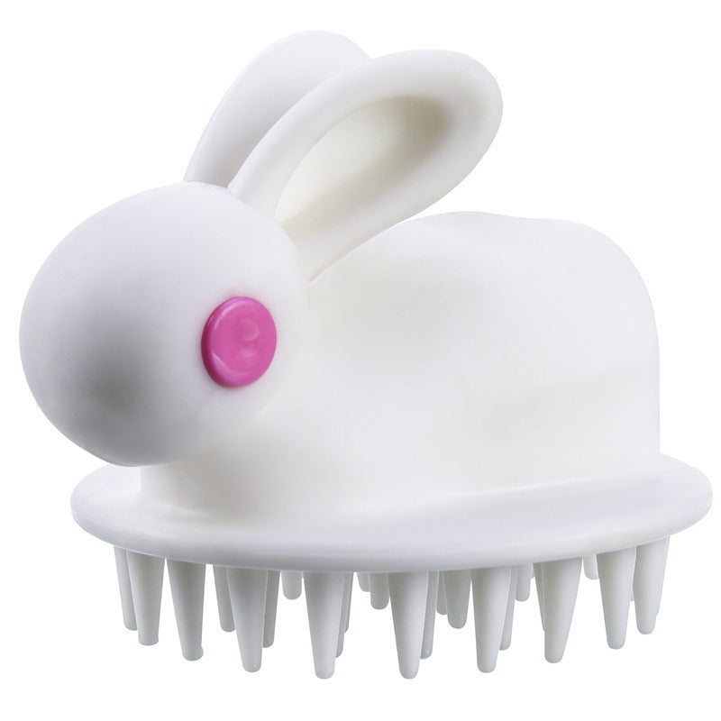 White bunny-shaped kids' scalp massage brush with soft silicone bristles and a pink eye detail.