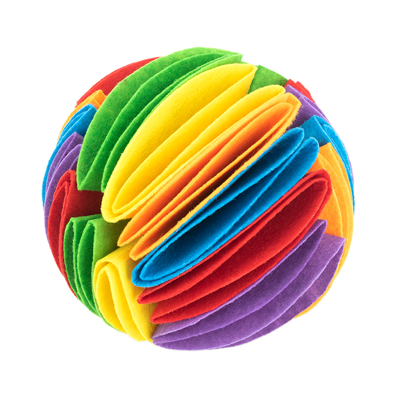 Multi-colored felt dog snuffle ball made of layered, rainbow-colored fabric petals for treat hiding.