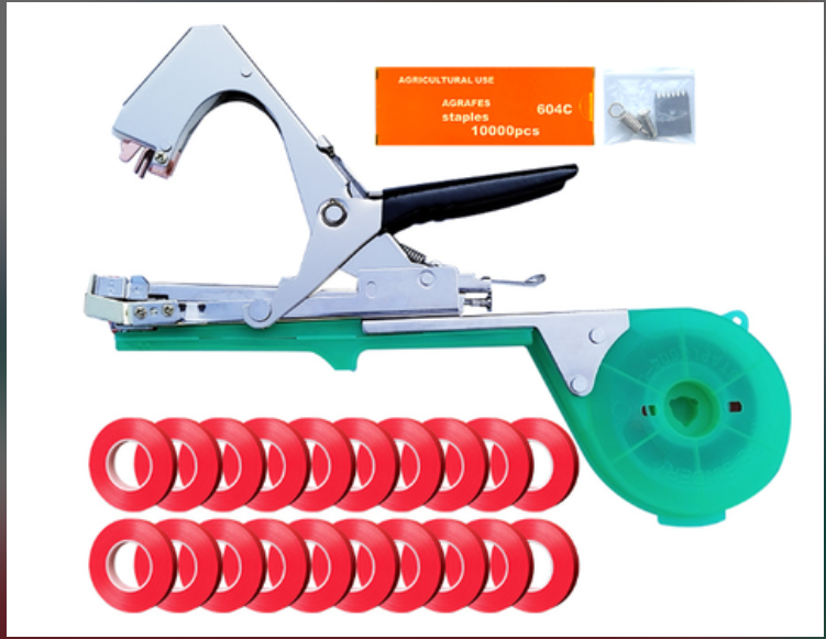 Garden plant tying tool with green plastic tape dispenser, metallic handle, 20 red tape rolls, and box of staples.