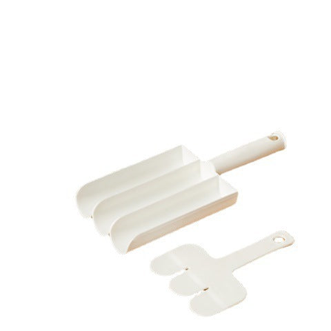 White plastic three-section meatball maker tool with a matching shaped spatula, isolated on a white background.