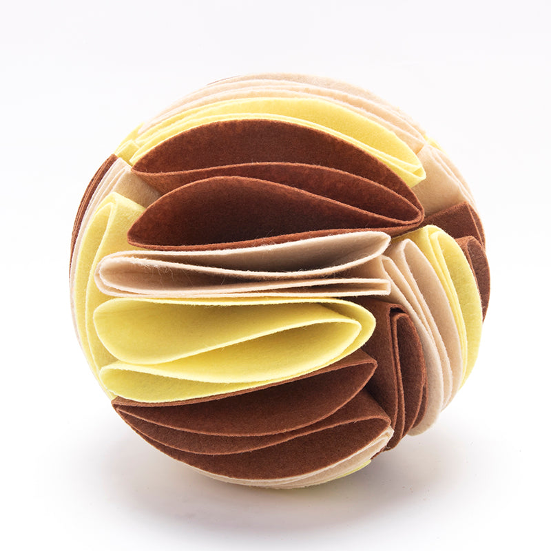 Round interactive dog snuffle ball made of layered felt in shades of dark brown, beige, and light yellow.