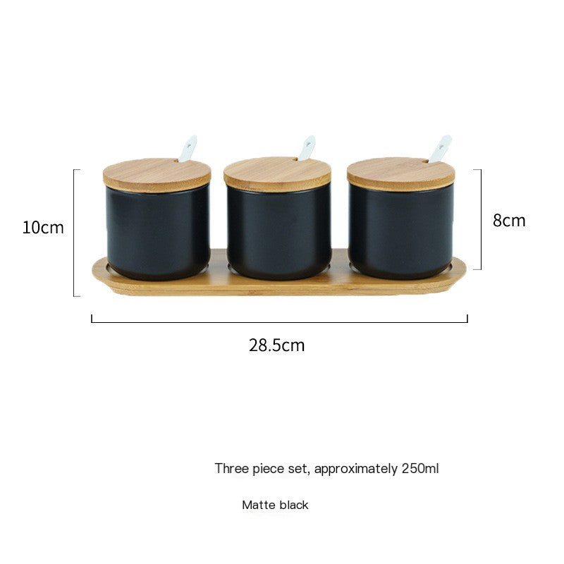 Three matte black ceramic spice jars with bamboo lids and spoons on a matching wooden tray, 250ml capacity each.