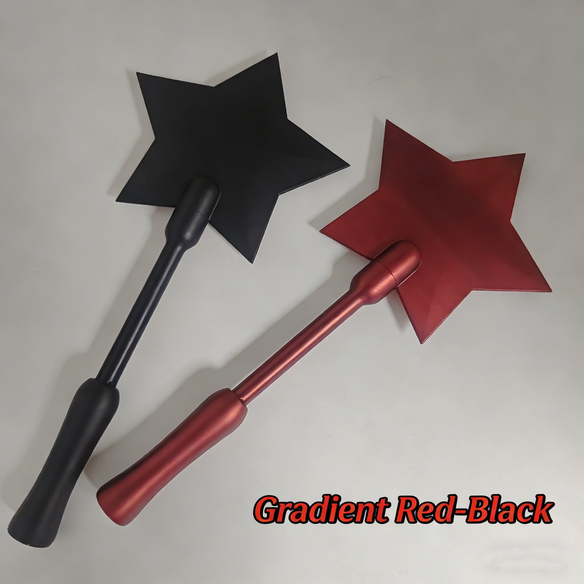 Two star-topped payment wands in matte black and metallic red, featuring sleek, minimalist handles.