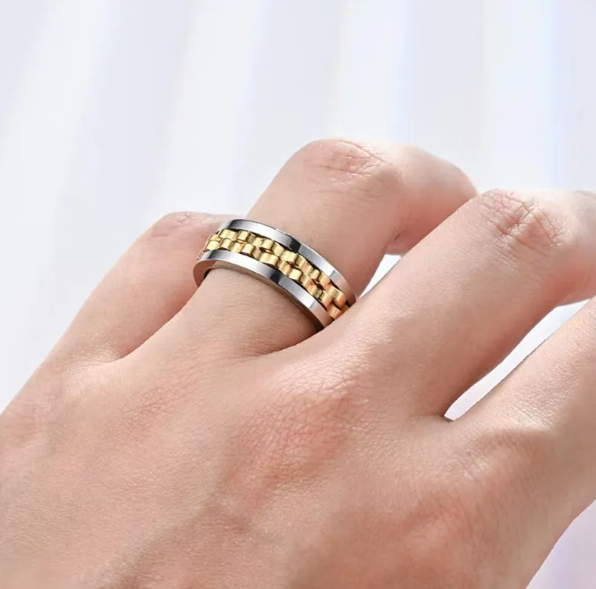 Two-tone titanium steel fidget ring featuring a rotating, gold-colored chain-link style band on a silver base.