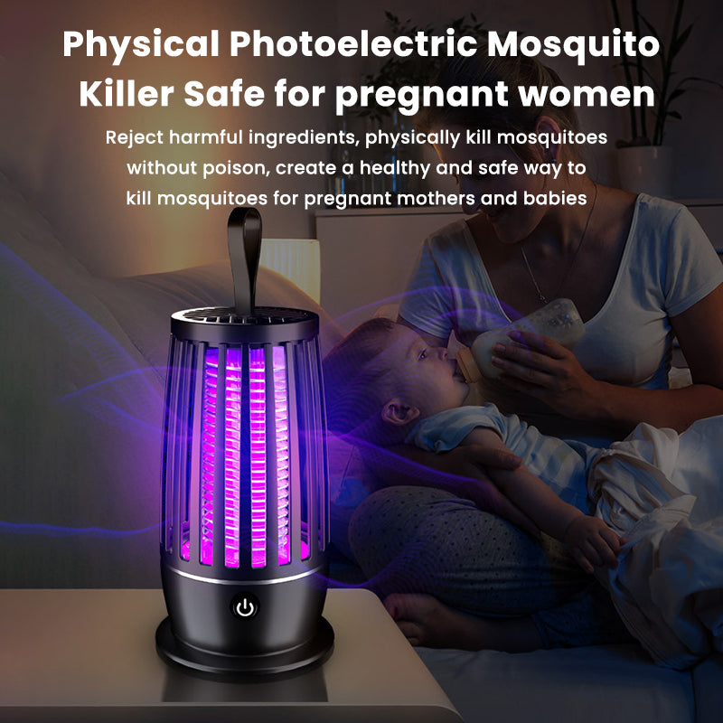 Portable black smart mosquito zapper lantern with a glowing purple light, placed on a table near a mother and baby.