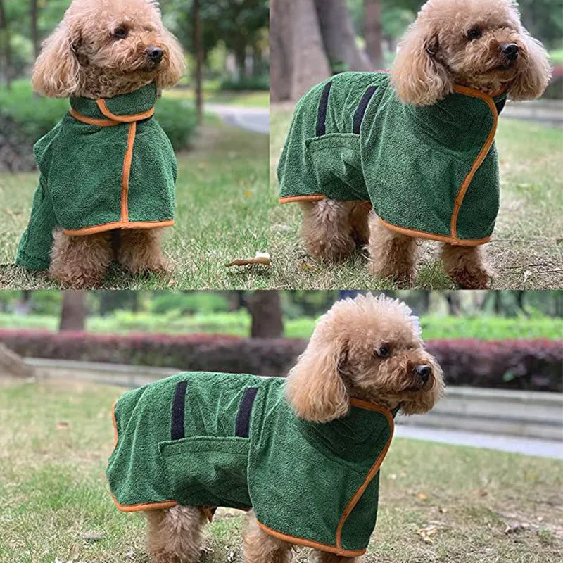 A curly-haired brown dog wears a green, quick-dry terry cloth pet bathrobe with orange trim and black velcro straps.