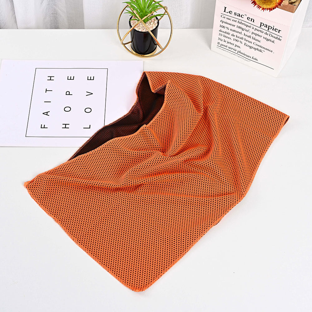 SwiftCool outdoor activity towel in bright orange with a textured mesh finish and dark brown interior.