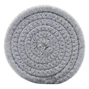 Round, grey artisan coaster crafted from coiled, woven cotton rope in a textured spiral pattern.