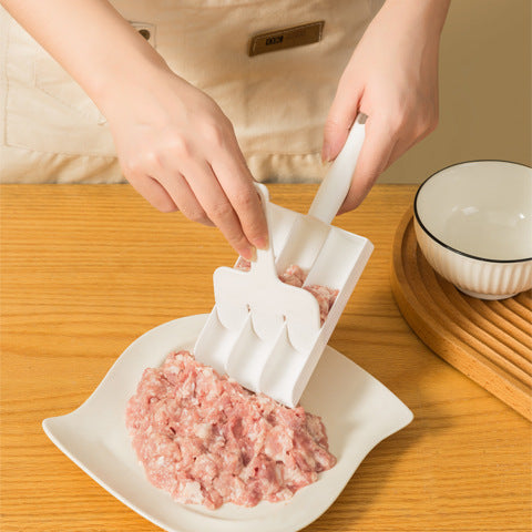 Person using a white plastic meatball maker tool to scoop and portion raw ground meat onto a plate.