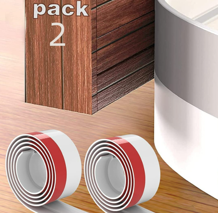 Two white, coiled rolls of adhesive door insulation strip with red backing against a wooden surface and door frame.
