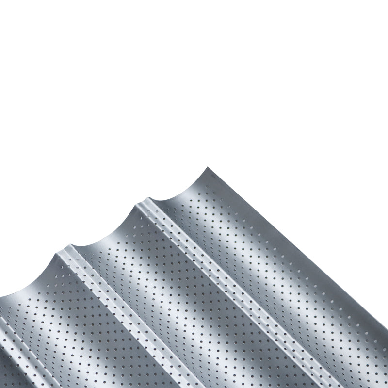 Silver metallic French loaf baker with a perforated, multi-channel design for even baking.