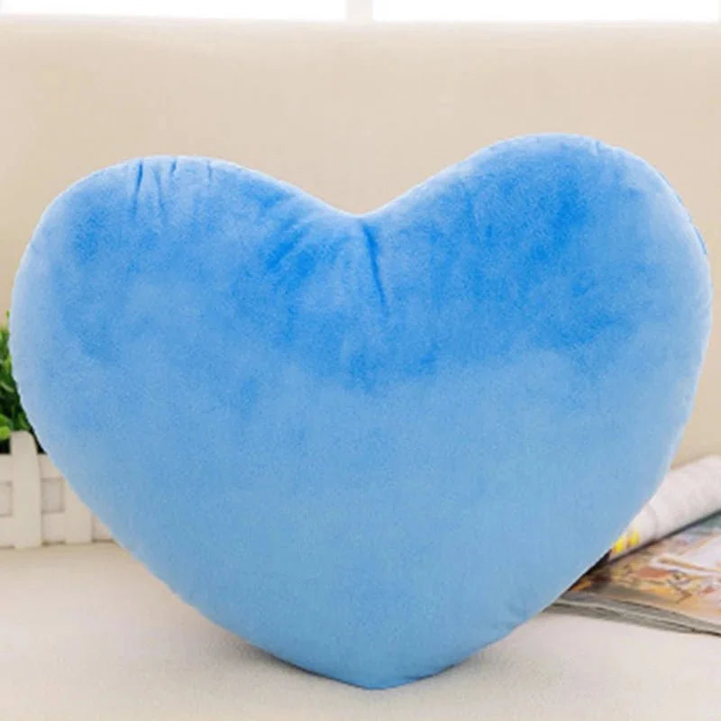 Soft, bright blue heart-shaped plush pillow with a smooth, velvet-like texture.