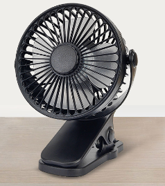 Compact black clip-on fan with a circular head, adjustable pivot, and silver fan blades on a light surface.