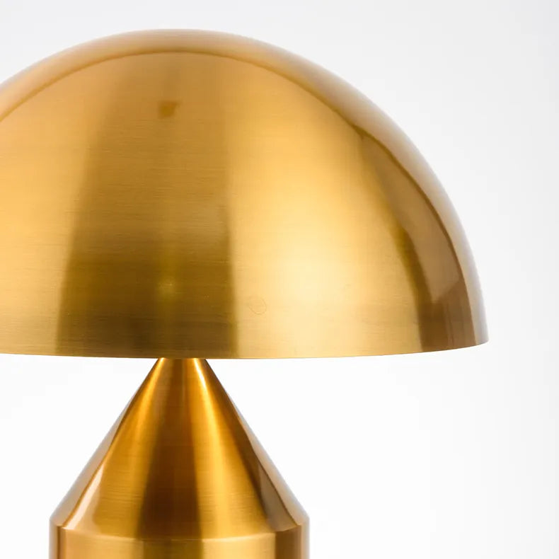 Mid-century modern mushroom desk lamp in a brushed copper finish with a rounded dome shade and conical base.