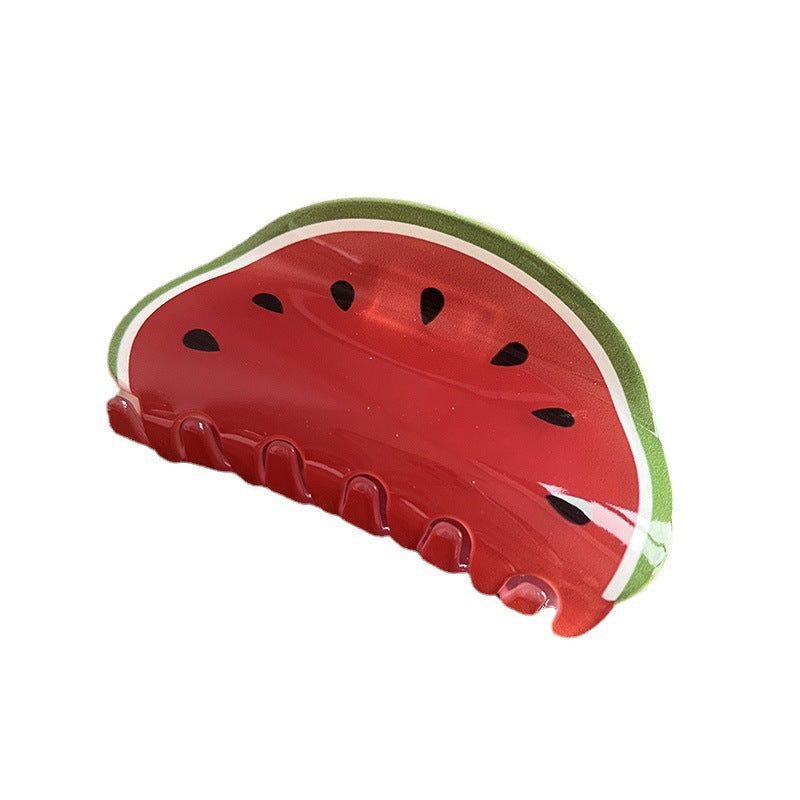 Watermelon-shaped acrylic hair claw in red, green, and white with black seed details against a white background.