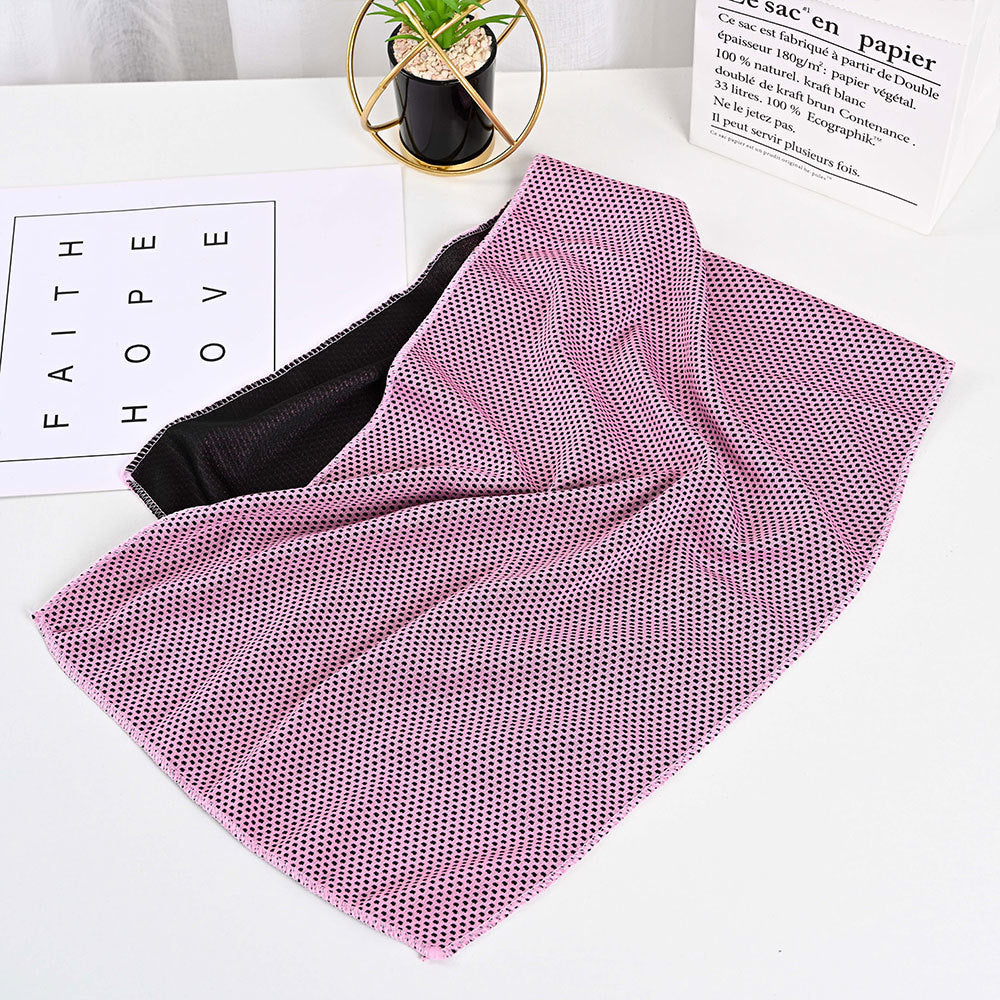 SwiftCool outdoor activity towel in pink and black with a textured, moisture-wicking mesh surface.