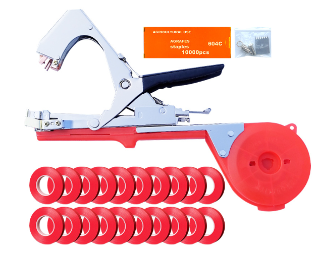 Garden plant tying machine in red and chrome with 20 rolls of red tape, a box of staples, and spare parts.