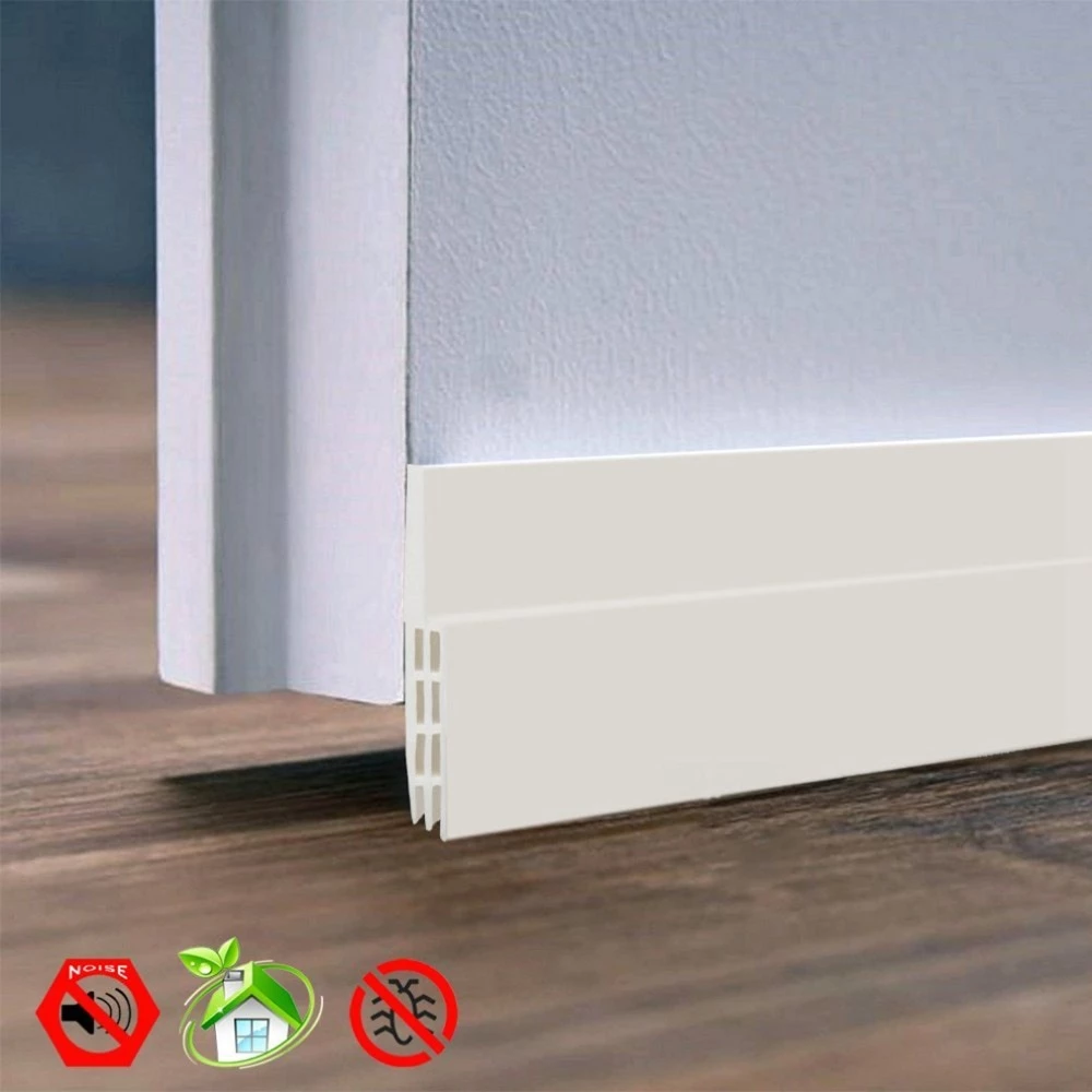 White silicone door draft stopper strip installed on a white door over dark wood flooring.