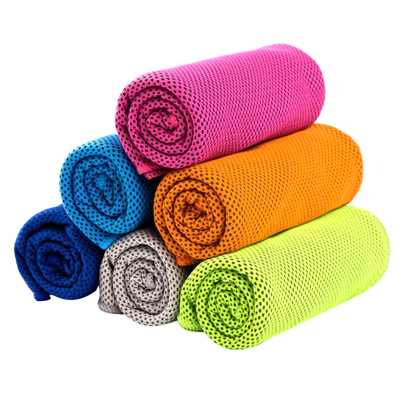Stack of six rolled SwiftCool outdoor activity towels in bright colors including pink, orange, lime, grey, and blue.