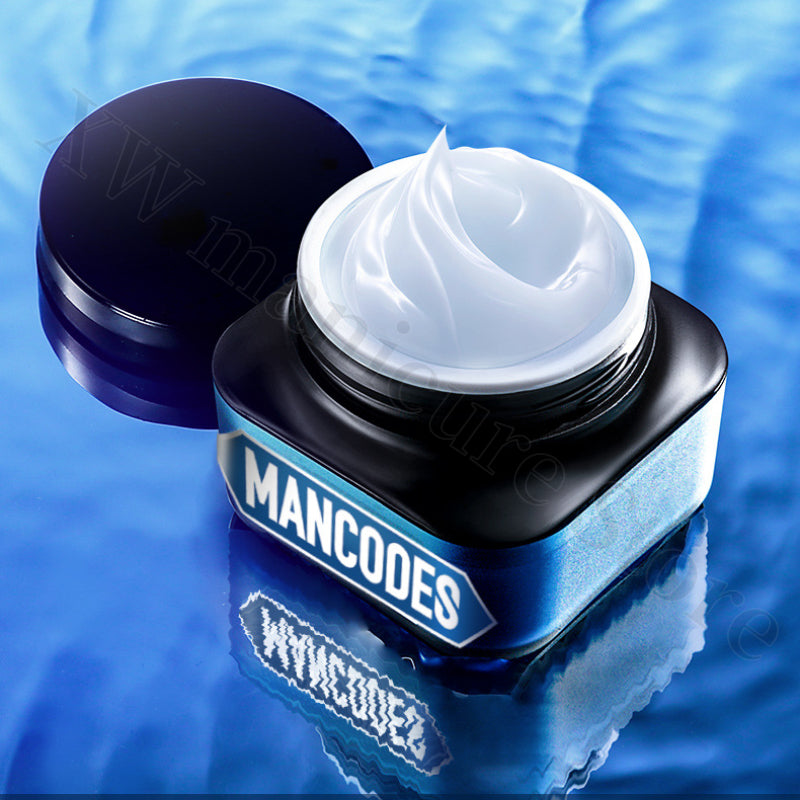 Open jar of MANCODES hydrating cream with a smooth white texture, set against a reflective blue water background.