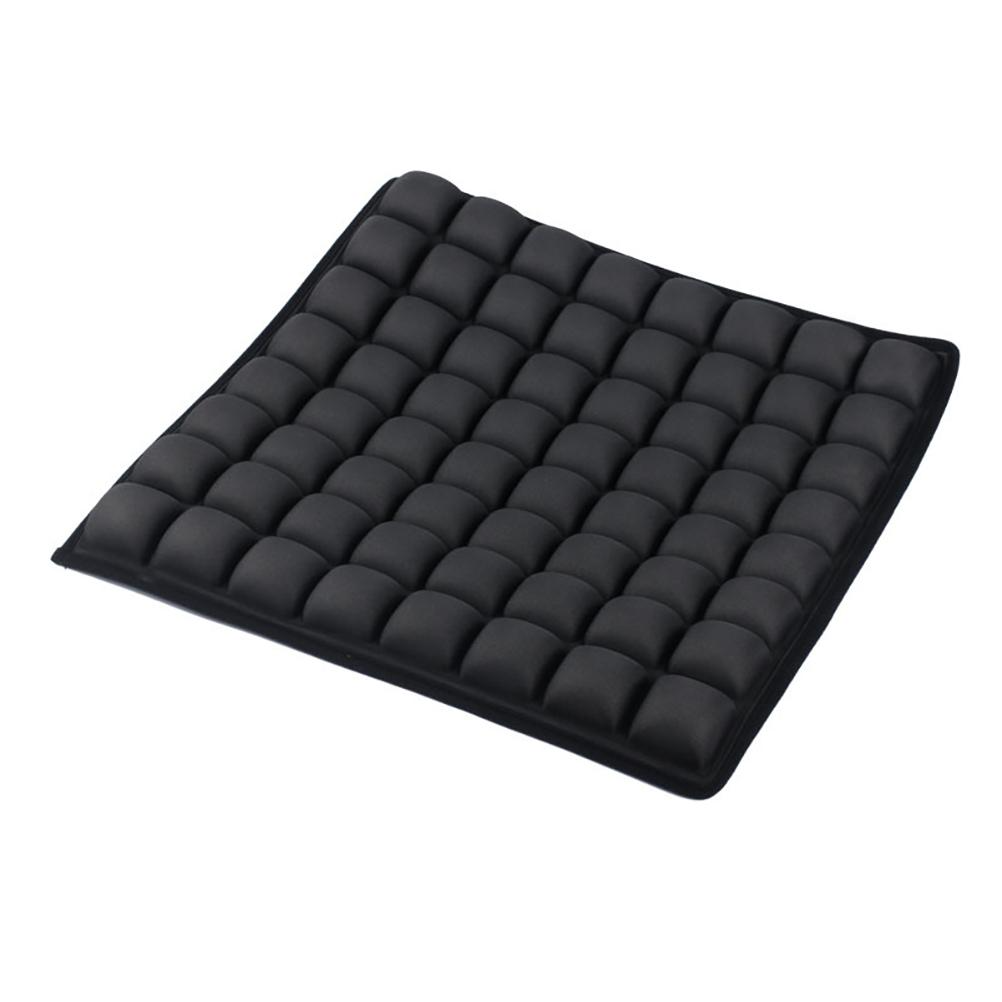 Black ergonomic seat cushion featuring a grid of individual air-filled square cells for pressure relief.
