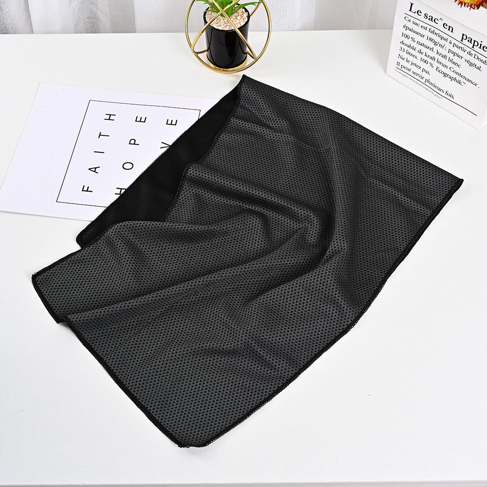 Black SwiftCool activity towel with a textured, breathable mesh fabric, displayed on a white tabletop.