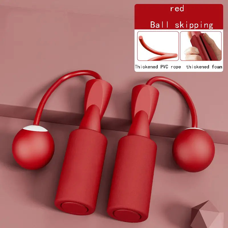 Red cordless jump rope set with foam handles and weighted PVC balls, showcasing a compact design for indoor fitness.