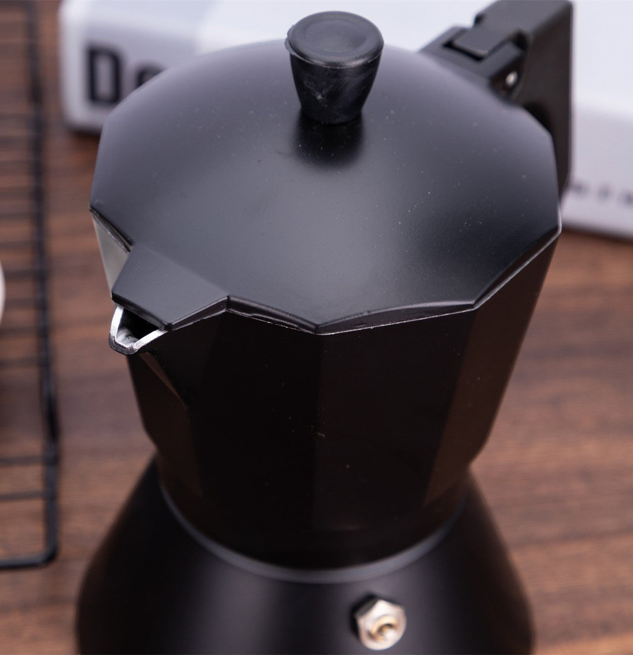 Creative Vault Marketplace black aluminum moka pot coffee maker with a modern faceted design and steam valve
