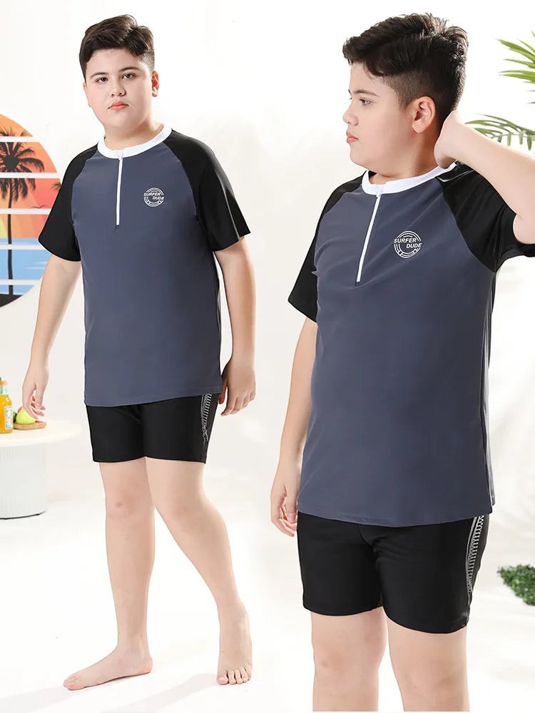 Creative Vault Marketplace plus size boys two-piece swimwear set with grey and black short-sleeve top, trunks, and cap.