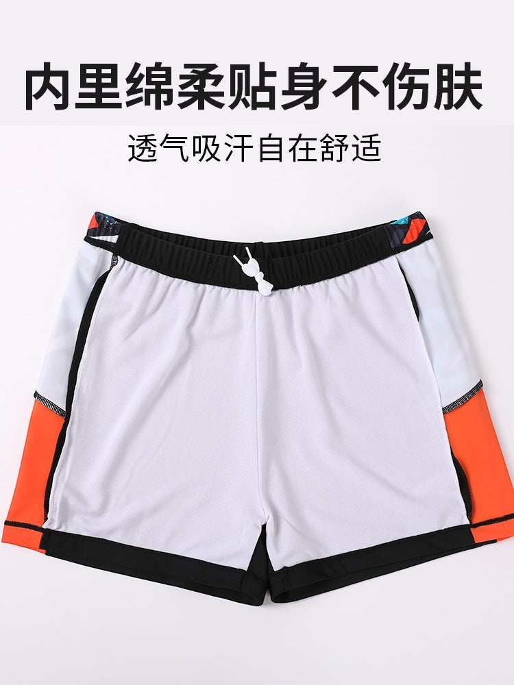 Creative Vault Marketplace boys' white swim trunks with orange and black accents and an elastic drawstring waist