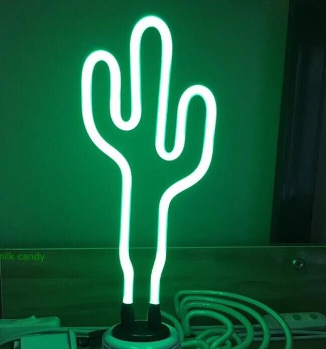 Creative Vault Marketplace cactus-shaped LED neon night light glowing with a vibrant green light on a desk