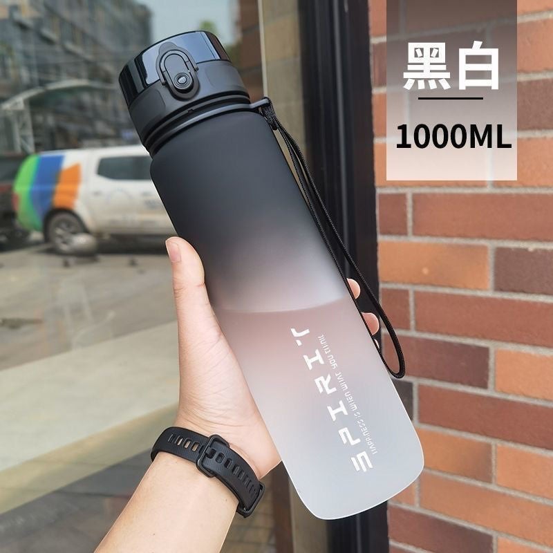 Creative Vault Marketplace 1000ml gradient black and white sports water bottle with a secure flip-top lid and strap.