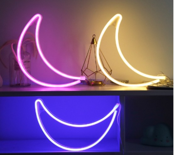 Creative Vault Marketplace crescent moon LED neon lights in pink, yellow, and blue glowing on a shelf