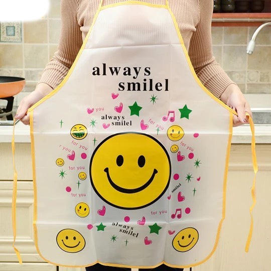 Creative Vault Marketplace waterproof PVC kitchen apron featuring a large yellow smiley face and playful icons