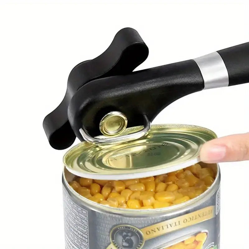 Creative Vault Marketplace stainless steel can opener with black handle opening a can of corn