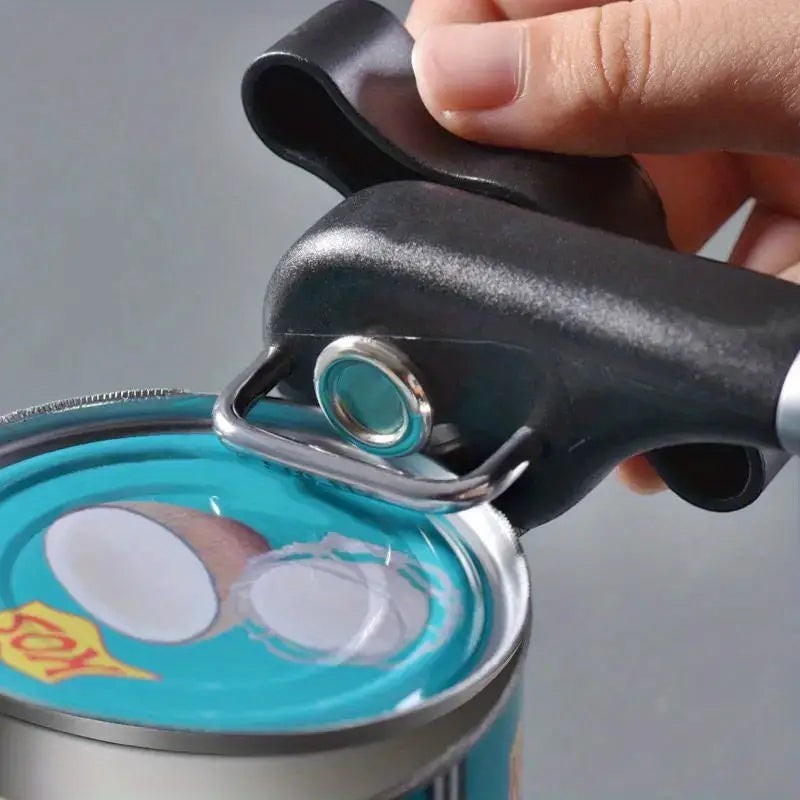 Creative Vault Marketplace stainless steel can opener with black ABS head and handle in use on a coconut milk can
