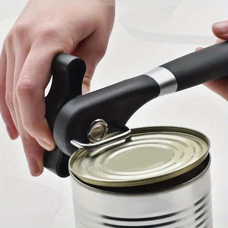Creative Vault Marketplace stainless steel can opener with black handle in use on a metal can