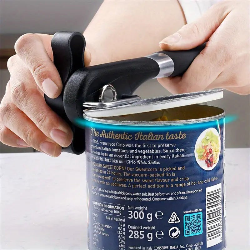 Creative Vault Marketplace stainless steel can opener with black handle cutting open a food tin