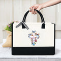 Cream and black cross of faith with butterfly and flower print canvas tote, suitable for church and daily use by Creative Vault Marketplace