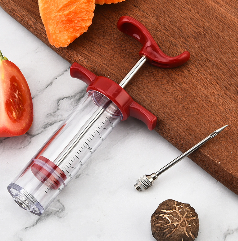 Red BBQ flavor injector syringe with clear measurement markings, stainless steel needle, and ergonomic handle.